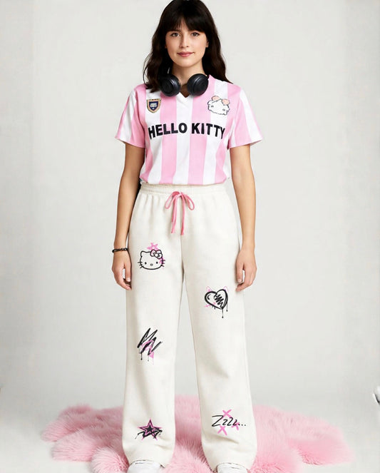 Person wearing a Hello Kitty-themed outfit with a pink and white striped shirt and white pants with designs.